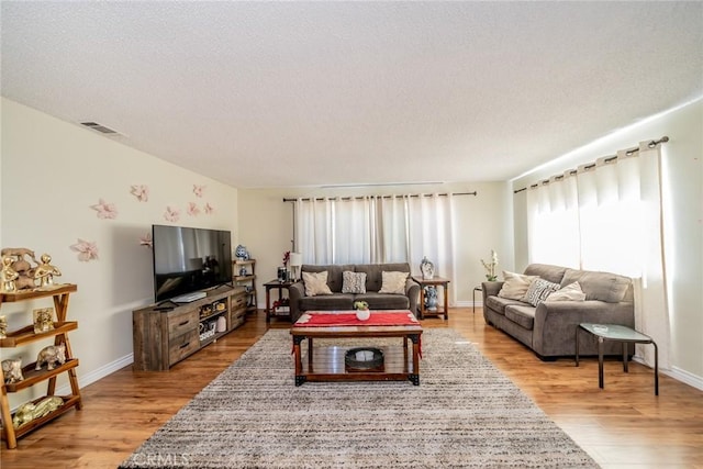12995 Leith Way, Yucaipa, CA 92399 - living area featuring a textured ceiling and light wood finished floors