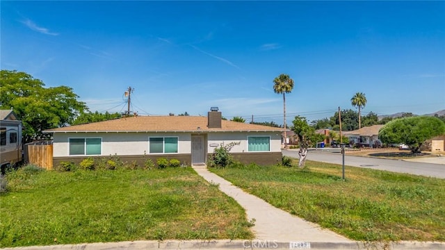 12995 Leith Way, Yucaipa, CA 92399 - single story home featuring a chimney, stucco siding, and a front lawn