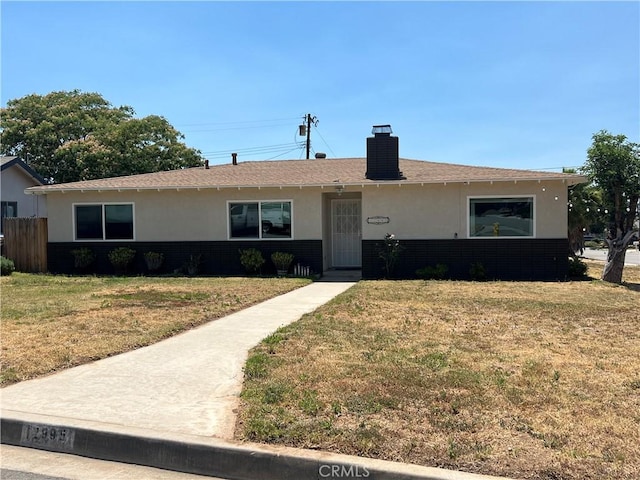 12995 Leith Way, Yucaipa, CA 92399 - view of front of property with stucco siding, a front lawn, a chimney, and roof with shingles