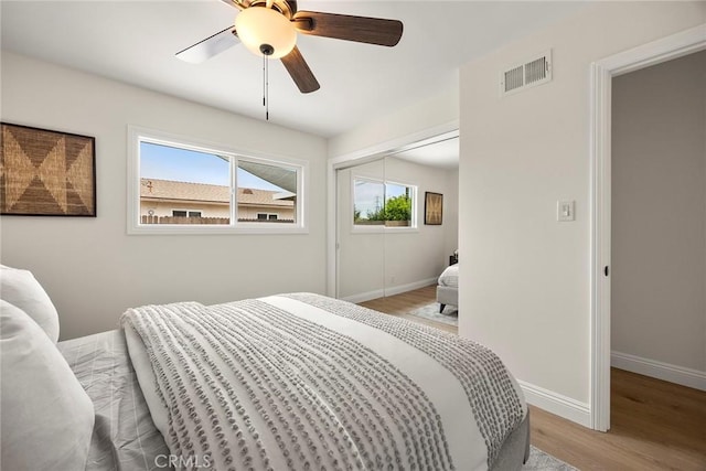 19331 Cindy Ln, Huntington Beach, CA 92646 - bedroom with light wood-style flooring, a ceiling fan, and a closet
