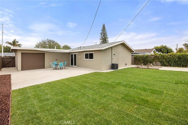 19331 Cindy Ln, Huntington Beach, CA 92646 - back of property with stucco siding, an attached garage, concrete driveway, and a patio