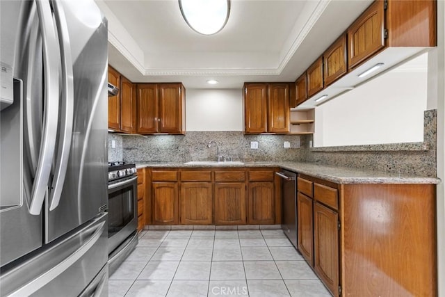 635 E Elmwood Ave Unit 307, Burbank, CA 91501 - kitchen with stainless steel appliances, brown cabinets, a raised ceiling, and decorative backsplash