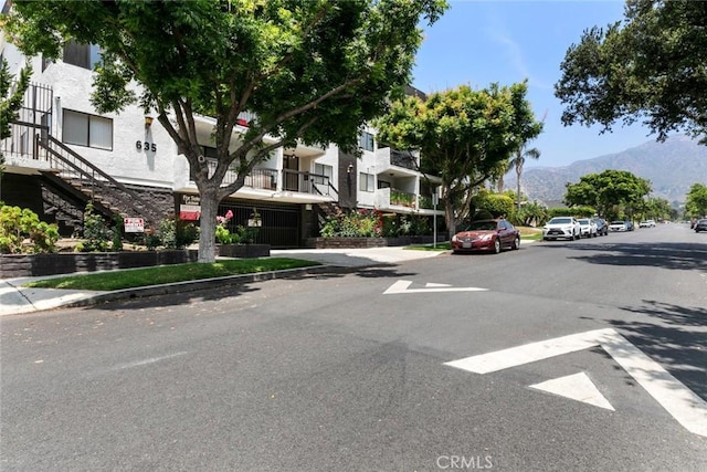 635 E Elmwood Ave Unit 307, Burbank, CA 91501 - view of asphalt street featuring sidewalks, curbs, a mountain view, and stairs