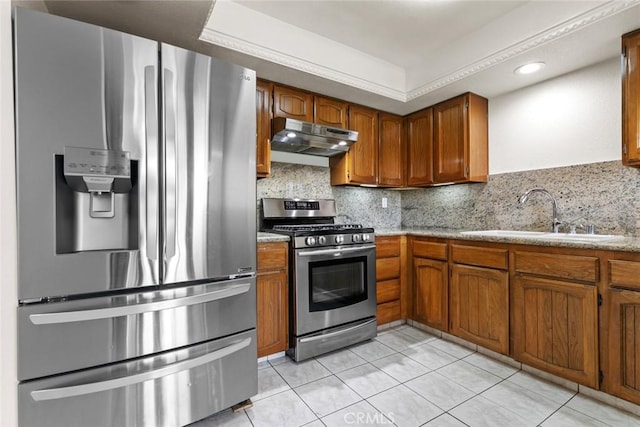 635 E Elmwood Ave Unit 307, Burbank, CA 91501 - kitchen featuring appliances with stainless steel finishes, under cabinet range hood, brown cabinetry, light tile patterned flooring, and recessed lighting