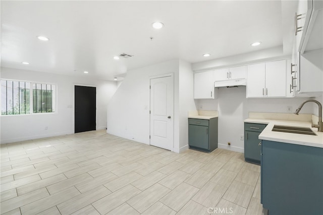 10415 Avalon Blvd, Los Angeles, CA 90003 - kitchen featuring under cabinet range hood, recessed lighting, white cabinets, light countertops, and open floor plan