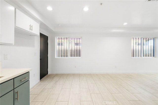 10415 Avalon Blvd, Los Angeles, CA 90003 - kitchen featuring plenty of natural light, light countertops, green cabinets, recessed lighting, and white cabinets