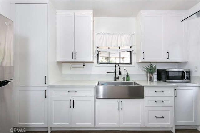4134 Rio Hondo Ave, Rosemead, CA 91770 - kitchen with appliances with stainless steel finishes, light countertops, and white cabinets