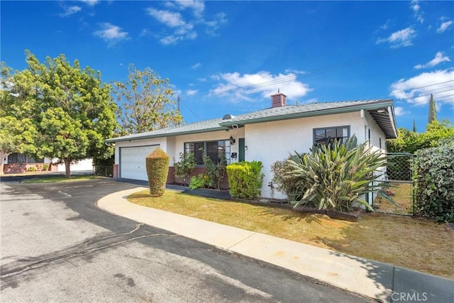 4134 Rio Hondo Ave, Rosemead, CA 91770 - view of front facade with stucco siding, asphalt driveway, an attached garage, a chimney, and a gate