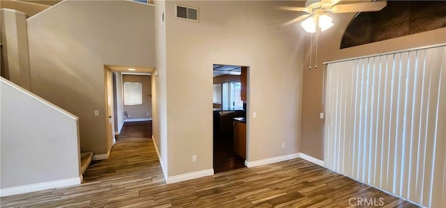 186 S Massachusetts St, Lake Elsinore, CA 92530 - empty room featuring ceiling fan, wood finished floors, and a towering ceiling