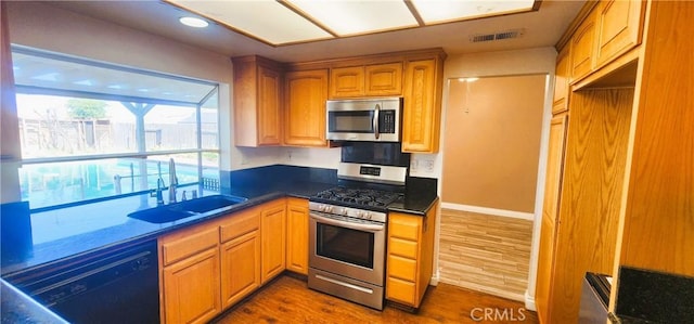 186 S Massachusetts St, Lake Elsinore, CA 92530 - kitchen featuring appliances with stainless steel finishes, dark countertops, dark wood-type flooring, and recessed lighting