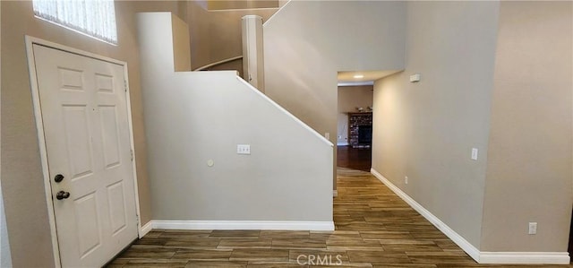 186 S Massachusetts St, Lake Elsinore, CA 92530 - foyer with wood finished floors, stairway, and a fireplace