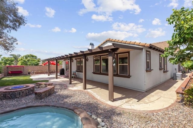 7145 Sunnyside Pl, Rancho Cucamonga, CA 91739 - back of house featuring a jacuzzi, a fire pit, a patio area, a tile roof, and stucco siding