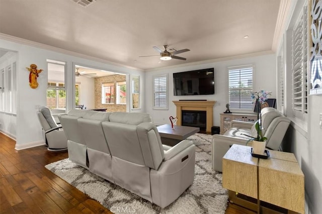 7145 Sunnyside Pl, Rancho Cucamonga, CA 91739 - living area with ceiling fan, ornamental molding, dark wood-type flooring, and a glass covered fireplace