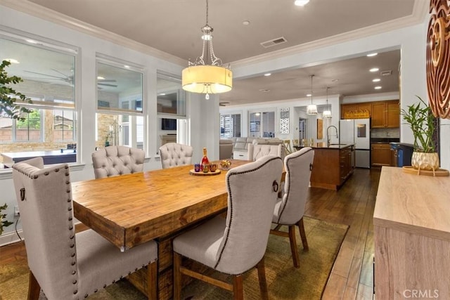 7145 Sunnyside Pl, Rancho Cucamonga, CA 91739 - dining area with dark wood-style flooring, ornamental molding, and recessed lighting