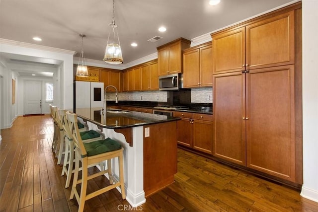 7145 Sunnyside Pl, Rancho Cucamonga, CA 91739 - kitchen with stainless steel appliances, dark wood-style flooring, brown cabinets, decorative backsplash, and crown molding