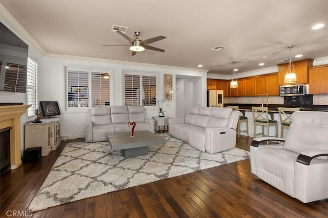 7145 Sunnyside Pl, Rancho Cucamonga, CA 91739 - living area with dark wood-style floors, ceiling fan, crown molding, recessed lighting, and a fireplace