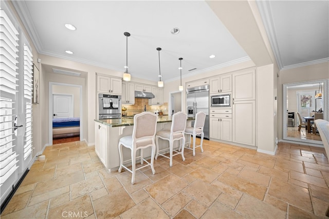 35 Twin Gables, Irvine, CA 92620 - kitchen featuring built in appliances, stone tile flooring, under cabinet range hood, a kitchen breakfast bar, and recessed lighting
