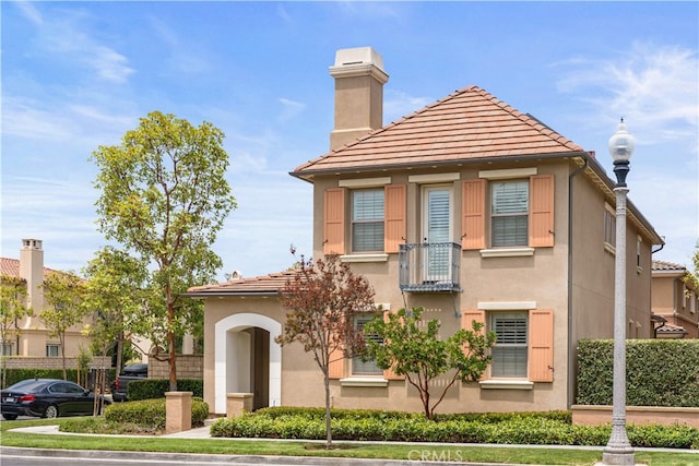 35 Twin Gables, Irvine, CA 92620 - view of front of house featuring a chimney, stucco siding, and a tiled roof