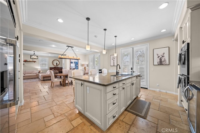35 Twin Gables, Irvine, CA 92620 - kitchen with stone tile floors, recessed lighting, dark stone counters, decorative light fixtures, and open floor plan