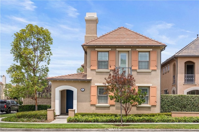 35 Twin Gables, Irvine, CA 92620 - view of front of house featuring stucco siding, a chimney, and a tile roof