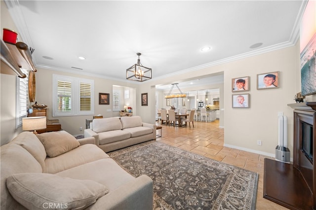35 Twin Gables, Irvine, CA 92620 - living room featuring a chandelier, stone tile floors, crown molding, and recessed lighting