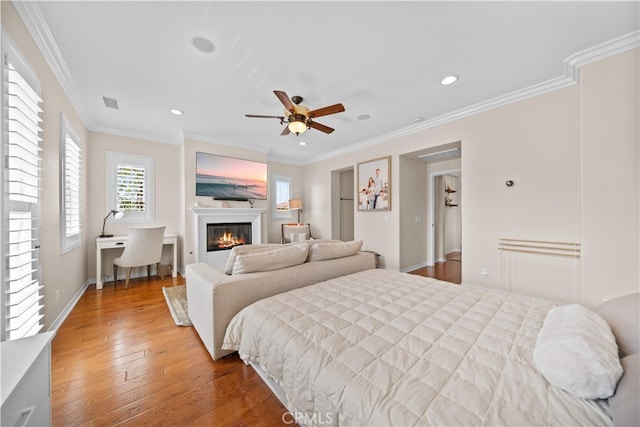 35 Twin Gables, Irvine, CA 92620 - bedroom with a glass covered fireplace, recessed lighting, wood-type flooring, crown molding, and ceiling fan