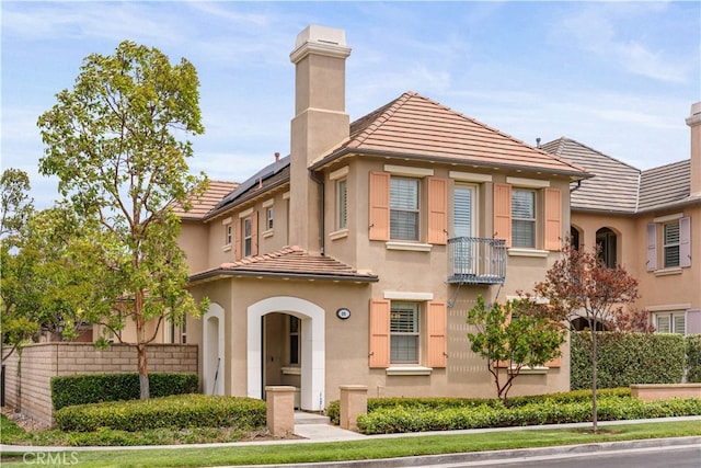35 Twin Gables, Irvine, CA 92620 - view of property featuring a chimney, a tile roof, and stucco siding