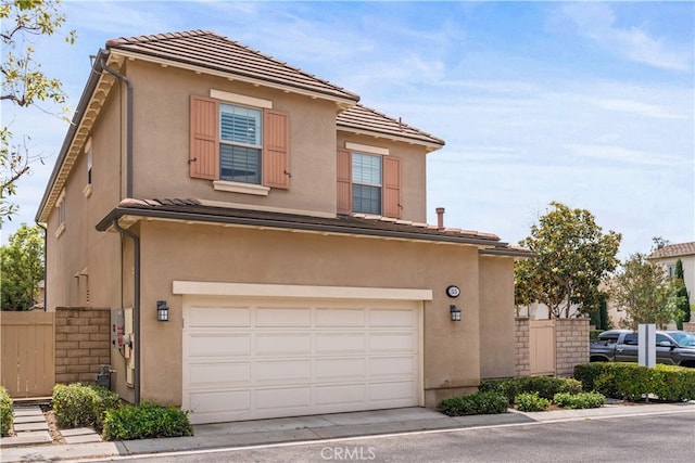 35 Twin Gables, Irvine, CA 92620 - view of front of house with an attached garage, stucco siding, and concrete driveway