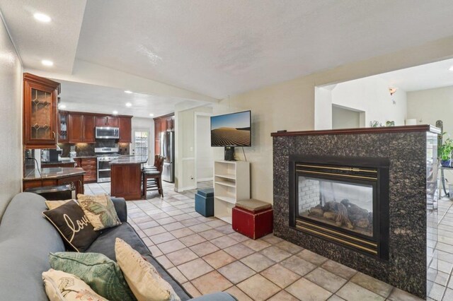 5070 Limerick Ave, Clairemont Mesa, CA 92117 - living area with recessed lighting, a high end fireplace, and vaulted ceiling