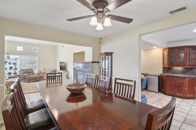 5070 Limerick Ave, Clairemont Mesa, CA 92117 - dining area with light tile patterned flooring, a ceiling fan, and a tiled fireplace