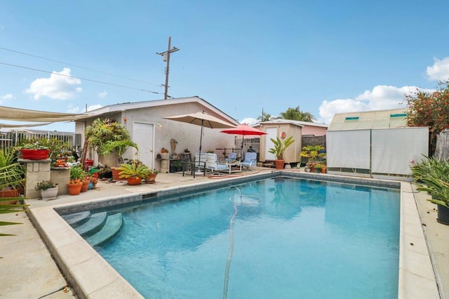 5070 Limerick Ave, Clairemont Mesa, CA 92117 - view of swimming pool with a shed, a fenced backyard, and a patio