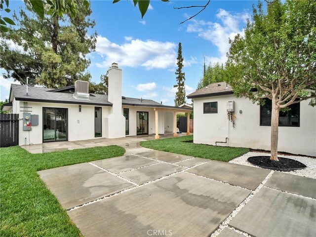 7055 Fallbrook Ave, West Hills, CA 91307 - back of house featuring a patio, stucco siding, and a chimney