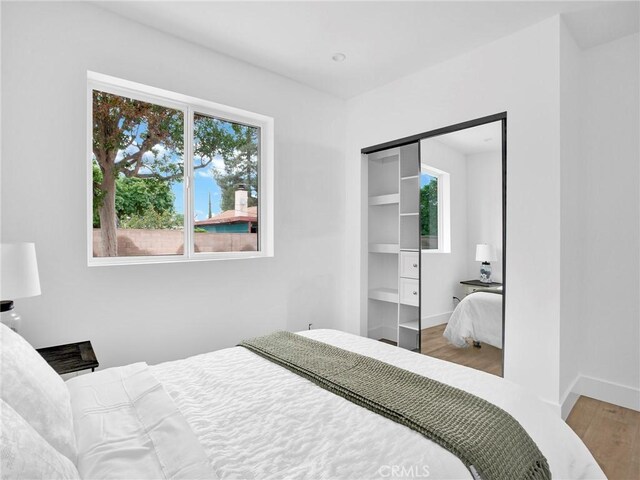7055 Fallbrook Ave, West Hills, CA 91307 - bedroom with wood finished floors and baseboards