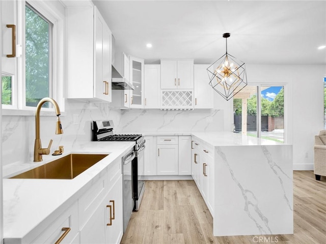 7055 Fallbrook Ave, West Hills, CA 91307 - kitchen with stainless steel gas range, a peninsula, recessed lighting, backsplash, and white cabinets