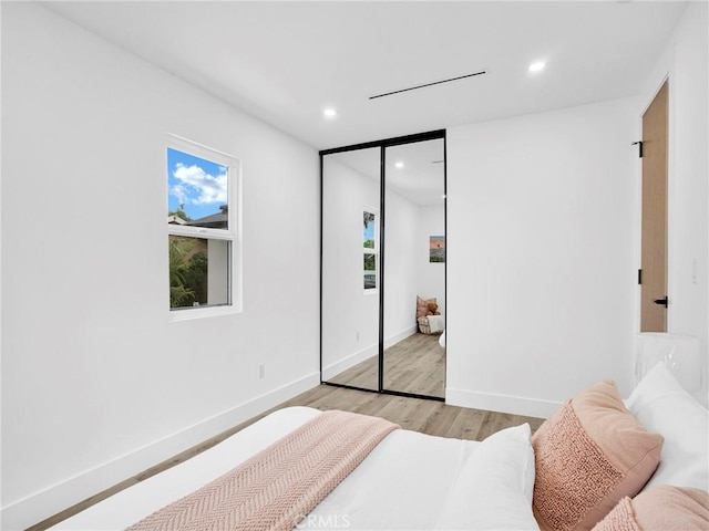 7055 Fallbrook Ave, West Hills, CA 91307 - bedroom featuring light wood-style flooring, recessed lighting, and a closet