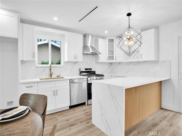 7055 Fallbrook Ave, West Hills, CA 91307 - kitchen with wall chimney range hood, appliances with stainless steel finishes, light wood-style floors, tasteful backsplash, and recessed lighting