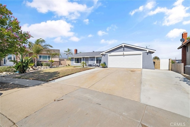 6963 Shamrock Ln, Rancho Cucamonga, CA 91701 - ranch-style house with concrete driveway, an attached garage, stucco siding, and a gate