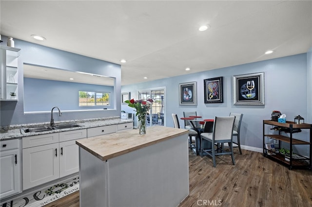 6963 Shamrock Ln, Rancho Cucamonga, CA 91701 - kitchen with butcher block counters, dark wood-type flooring, white cabinets, recessed lighting, and a center island