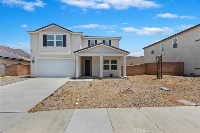 21288 Telegraph Rd, Riverside, CA 92507 - traditional-style home featuring an attached garage, covered porch, concrete driveway, and stucco siding