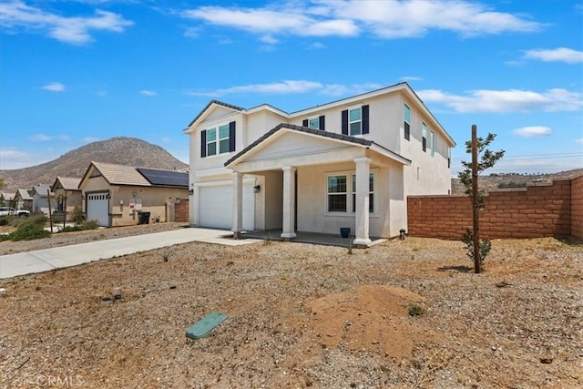 21288 Telegraph Rd, Riverside, CA 92507 - view of front of home featuring covered porch, an attached garage, a mountain view, driveway, and stucco siding