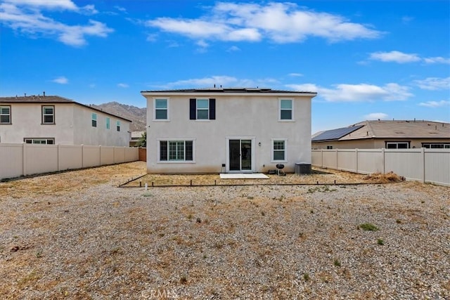 21288 Telegraph Rd, Riverside, CA 92507 - back of house featuring a fenced backyard, roof mounted solar panels, and stucco siding