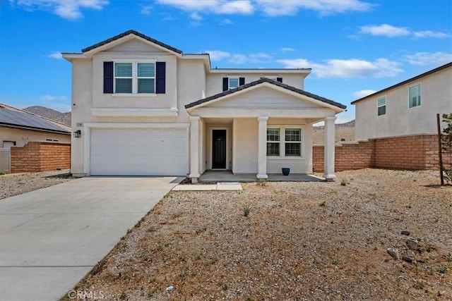 21288 Telegraph Rd, Riverside, CA 92507 - view of front of property featuring covered porch, a garage, driveway, and stucco siding