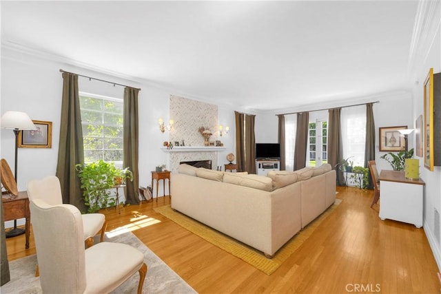 929 E Marshall Pl, Long Beach, CA 90807 - living area featuring crown molding, light wood-type flooring, and a fireplace