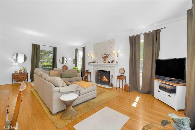 929 E Marshall Pl, Long Beach, CA 90807 - living area featuring a fireplace with flush hearth, crown molding, and light wood-style flooring