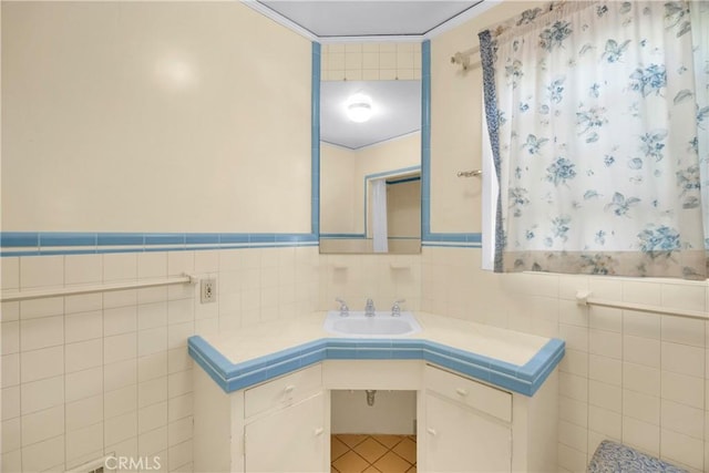 929 E Marshall Pl, Long Beach, CA 90807 - bathroom featuring tile walls, vanity, and a wainscoted wall