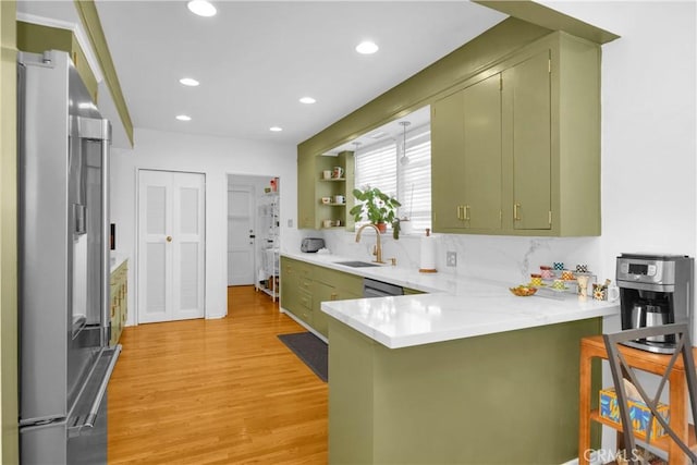 929 E Marshall Pl, Long Beach, CA 90807 - kitchen featuring green cabinets, stainless steel appliances, a peninsula, light wood finished floors, and light countertops