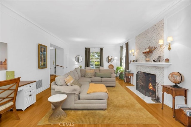 929 E Marshall Pl, Long Beach, CA 90807 - living area with a fireplace, wood finished floors, and ornamental molding