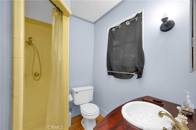 929 E Marshall Pl, Long Beach, CA 90807 - full bathroom featuring a stall shower, ornamental molding, and wood finished floors