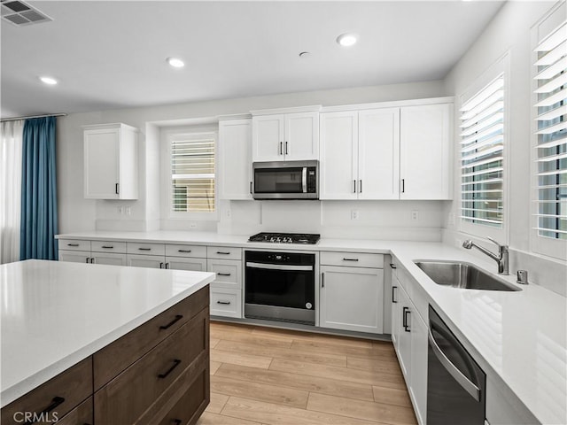 27148 Valley Oak Pl, Valencia, CA 91381 - kitchen with stainless steel appliances, plenty of natural light, white cabinets, and recessed lighting
