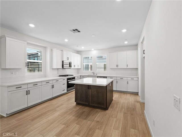 27148 Valley Oak Pl, Valencia, CA 91381 - kitchen with wall oven, stainless steel microwave, white cabinets, black gas cooktop, and recessed lighting